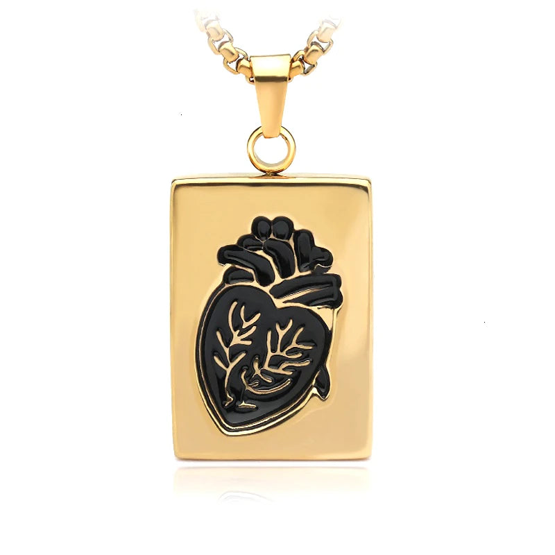 Gold pendant with black heart design on a white background